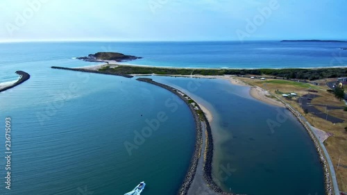 Aerial view straight down of boat exiting the inlet photo