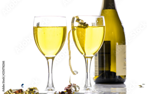 Two glasses with wine, champagne on the background of the bottle and tinsel