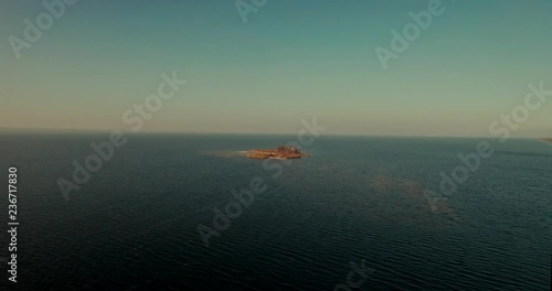 Aerial Drone small island on river and lake on autumn in golden hour.Kiev sea river island aerial drone fotage. The camera flies around the small round island. drone footage aerial view from above. 