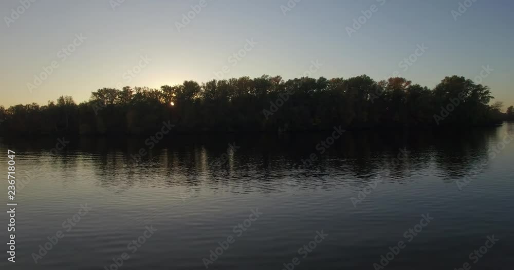 Flying over beautiful autumn river,forest and lake.Drone landscape on the river.a beautiful forest by the lake, a kind of high.Aerial: landscape with a view of the lake. autumn period, a sunny sunrise Flying over beautiful autumn river,forest and lake.Drone landscape on the river.a beautiful forest by the lake, a kind of high.Aerial: landscape with a view of the lake. autumn period, a sunny sunrise