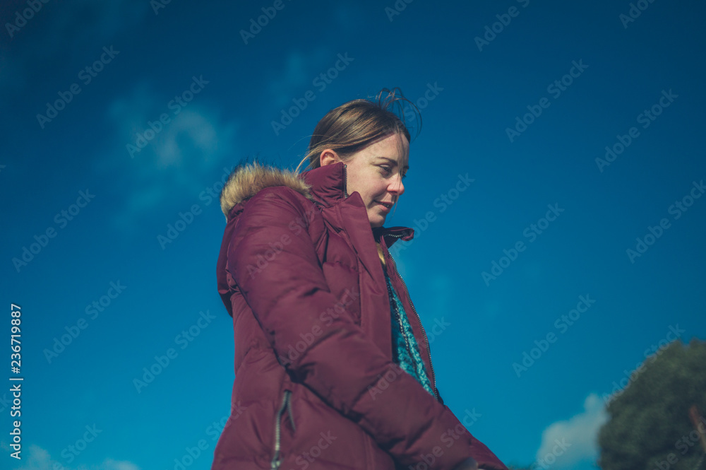 Young woman walking outdoors in winter