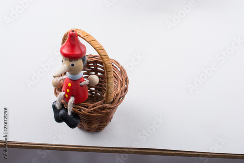 Pinochio toy figurine sitting in a basket