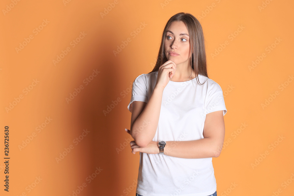 Image of thoughtful young woman posing isolated on yellow background. Image of thoughtful young woman posing isolated on yellow background.
