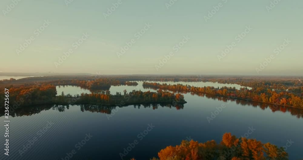 Aerial Fog above the water Aerial the morning mist Drone mist fog over lake.Amazing autumn sunrise, reflections on water surface. Fog above the water. Aerial: the morning mist, surrounded by autumn. Aerial Fog above the water Aerial the morning mist Drone mist fog over lake.Amazing autumn sunrise, reflections on water surface. Fog above the water. Aerial: the morning mist, surrounded by autumn.