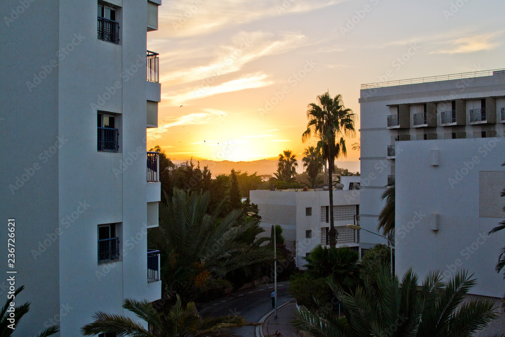 Fototapeta premium Sunset in the Moroccan white city, view from the window
