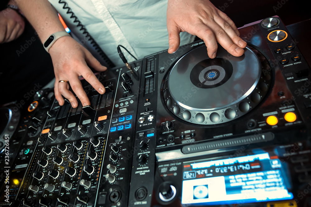 Obraz premium Dj mixer with headphones at nightclub