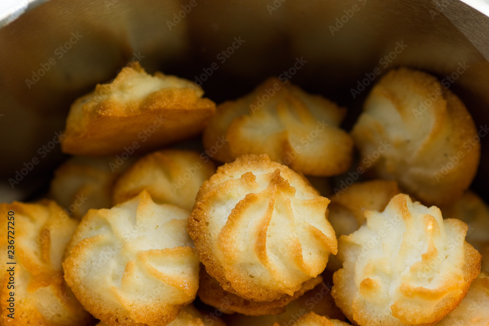 Christmas coconut puffs macaroon cookies in tin box. Festive cozy atmosphere. Holiday pastry baking concept. Italian French cuisine
