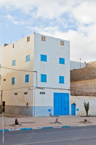 Traditional white houses with blue shutters and doors