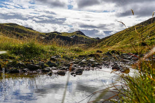 A Glaciel River runs through an Icelandic Landscape. photo