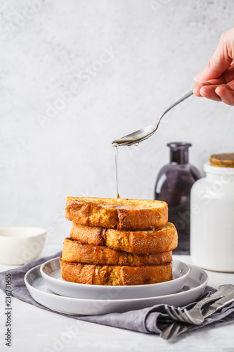 Obraz na plátně French toast with syrup on a gray plate.