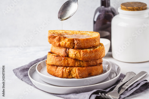 French toast with syrup on a gray plate.