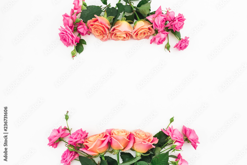Floral frame of pink roses and green leaves on white background. Flat lay, top view. Flower background Floral frame of pink roses and green leaves on white background. Flat lay, top view. Flower background