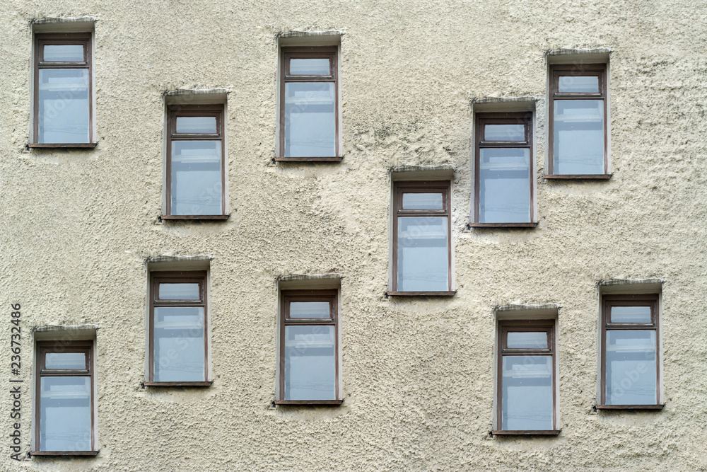 Randomly located windows on a concrete wall