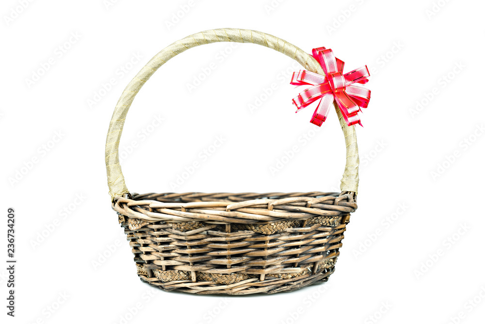 Empty wicker basket with red and gold ribbon isolated on white background