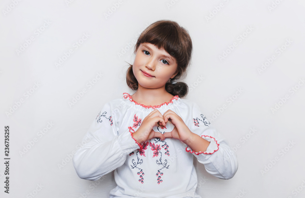 Little Ukrainian girl makes a heart shape with her hands. Love to motherland. Patriotic feelings. Little Ukrainian girl makes a heart shape with her hands. Love to motherland. Patriotic feelings.