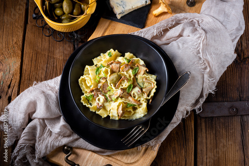 Reginette noodles in cream sauce with fresh chanterelles and capers