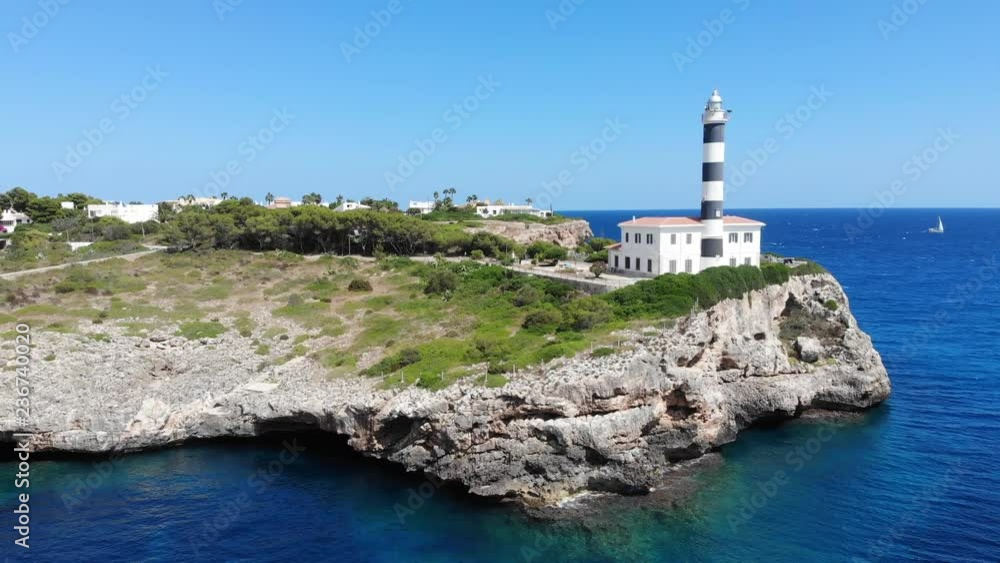 Flight over the Lighthouse, village Portocolom, Felanix region, Punta de ses Creste, Mallorca, Balearic Islands, Spain Flight over the Lighthouse, village Portocolom, Felanix region, Punta de ses Creste, Mallorca, Balearic Islands, Spain