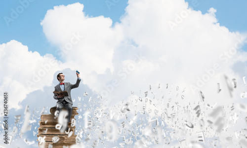 Young businessman or student studying the science and symbols fly around © adam121