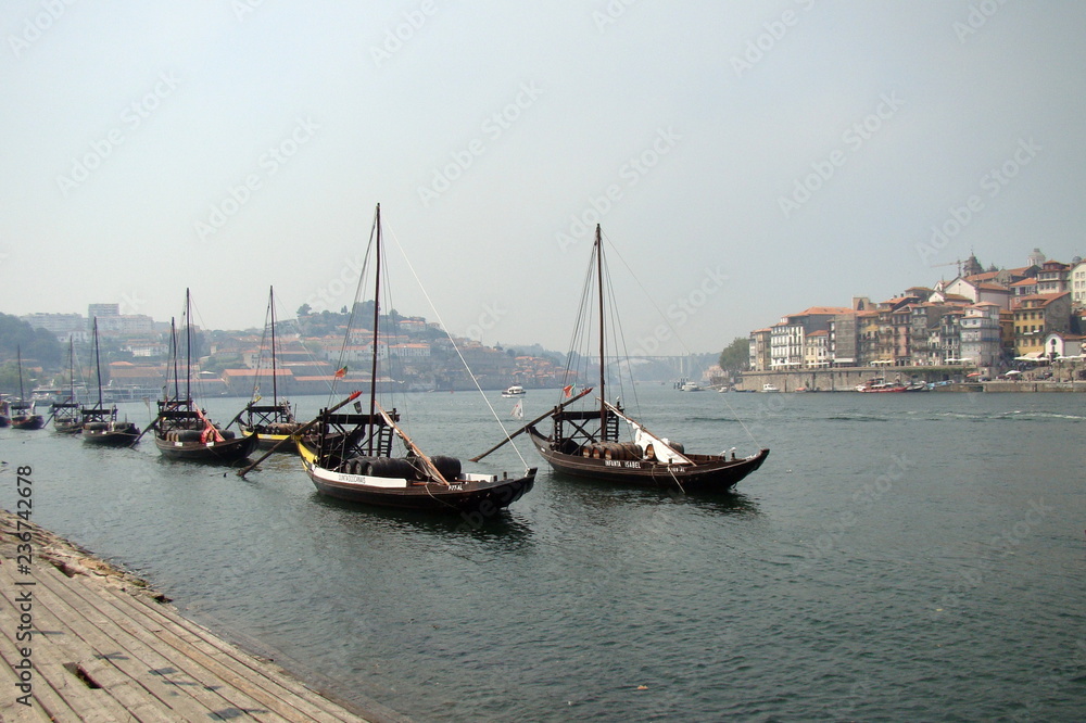 Boats with barrels of wine on the Douro river in Porto