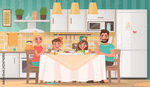 Happy family eating in the kitchen. Father, mother, son and daughter have breakfast at the table at home