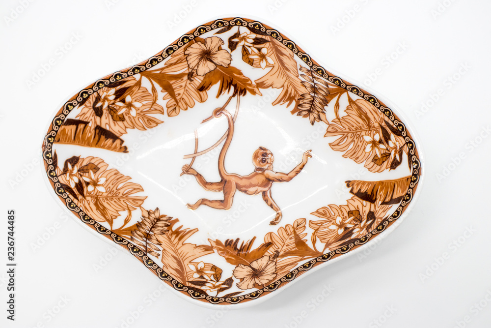 Fototapeta premium Saucer with image of a monkey in the jungle isolated on white background