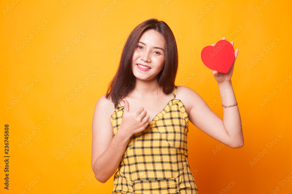 Asian woman thumbs up with red heart. Asian woman thumbs up with red heart.