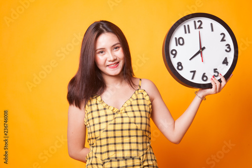 Young Asian woman with a clock.