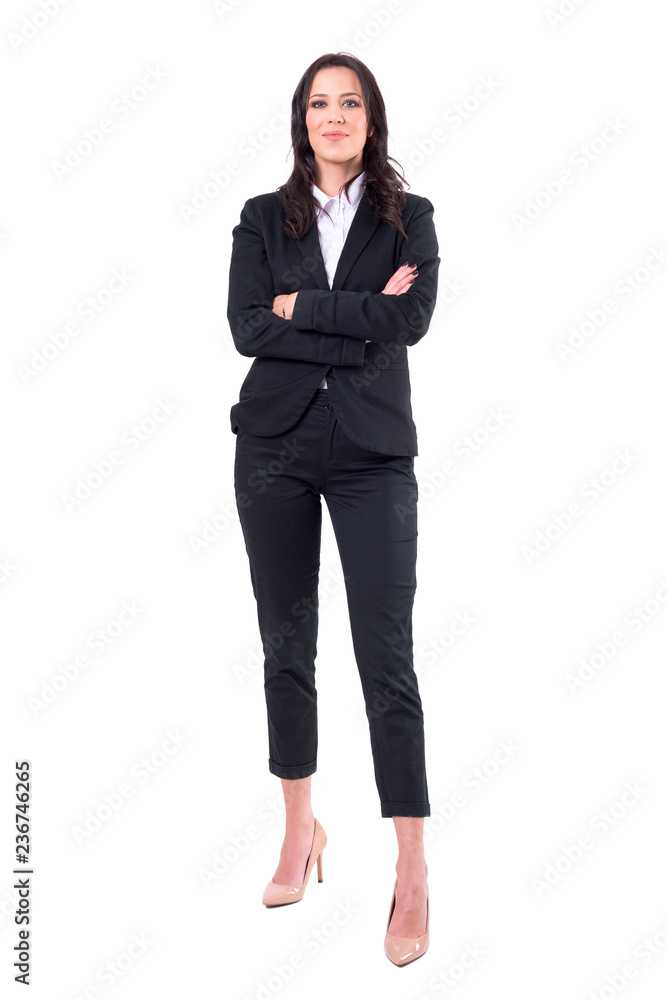 Happy smiling successful young female business manager with crossed arms in elegant black suit. Full body isolated on white background. Happy smiling successful young female business manager with crossed arms in elegant black suit. Full body isolated on white background.