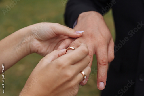 wedding couple wearing gold finger rings