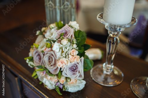 wedding bouquet and  candles on the table
