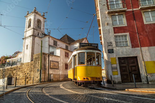 Yellow tram on the streets of Lisbon, Alfama, Portugal near Santa Luzia church