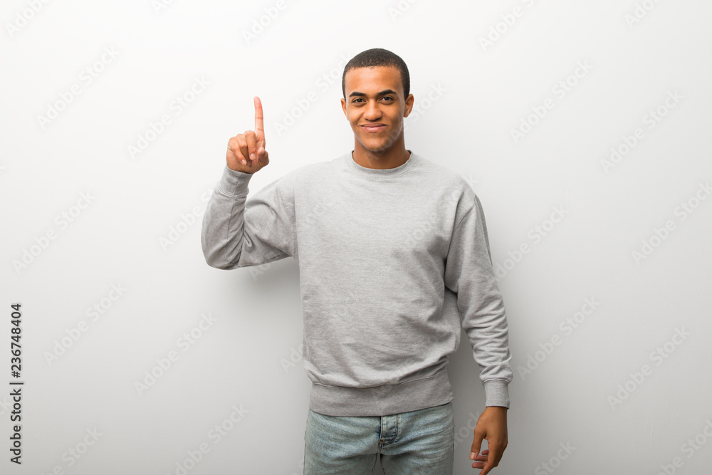 African american man on white wall background showing and lifting a finger in sign of the best African american man on white wall background showing and lifting a finger in sign of the best