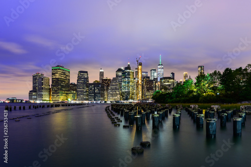 Manhattan panoramic skyline at night from Brooklyn Bridge Park. New York City  USA. Office buildings and skyscrapers at Lower Manhattan  Downtown Manhattan ..