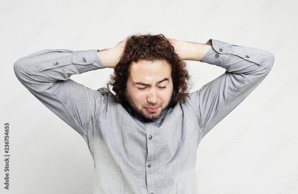 lifestyle, health and people concept: Close up of frustrated young man with head in hand lifestyle, health and people concept: Close up of frustrated young man with head in hand