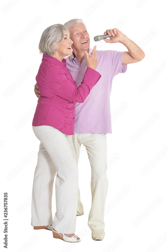 Senior couple singing karaoke on white background Senior couple singing karaoke on white background