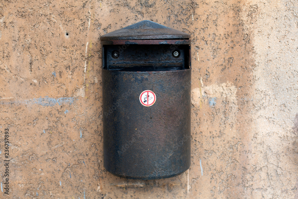 Old metal trash wall waste bin on the wall Old metal trash wall waste bin on the wall