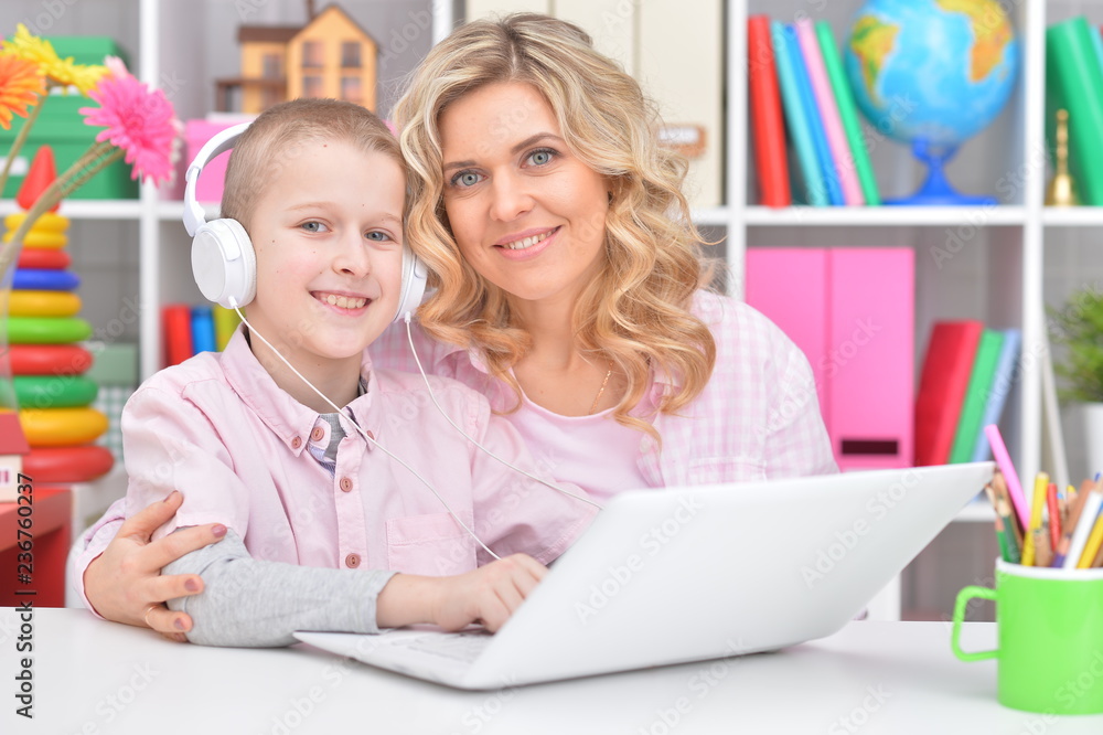 Portrait of mother and son using laptop together Portrait of mother and son using laptop together