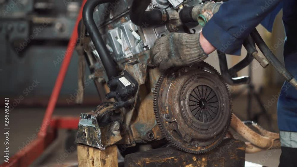 repair of the engine of the car, the repairman is engaged in restoration of the engine of the motor repair of the engine of the car, the repairman is engaged in restoration of the engine of the motor
