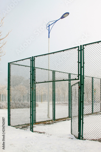 Tennis court fence in the snow