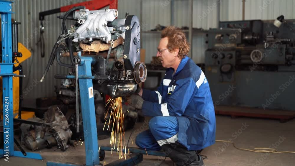 repair of the engine of the car, the repairman is engaged in restoration of the engine of the motor repair of the engine of the car, the repairman is engaged in restoration of the engine of the motor