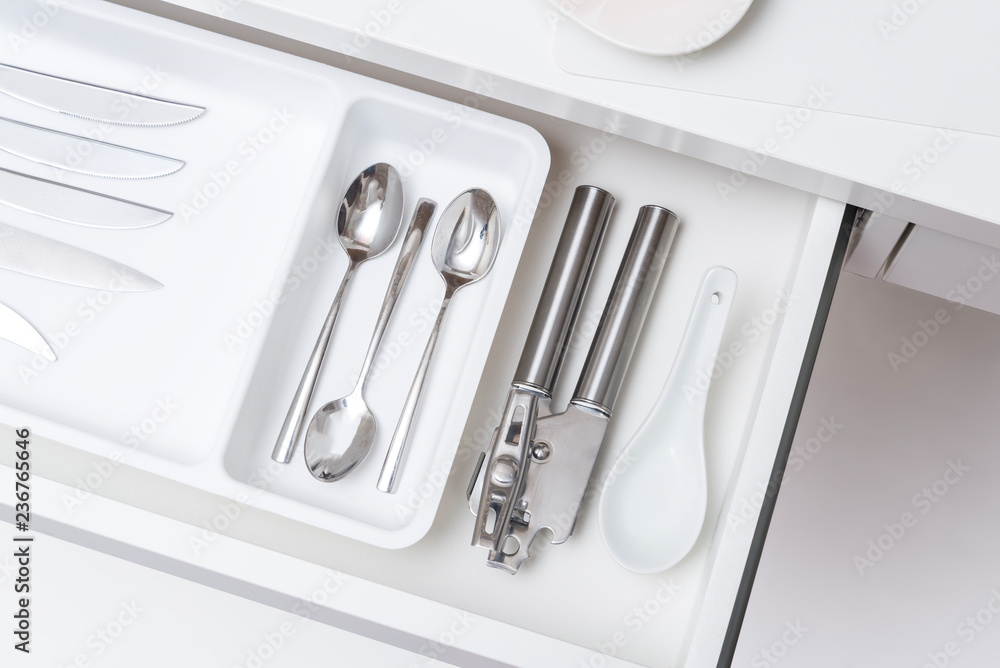 Inside of kitchen opened driwer with metal cutlery tolls Inside of kitchen opened driwer with metal cutlery tolls