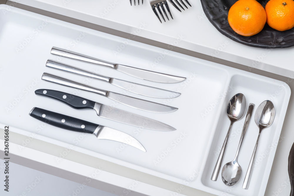 Inside of kitchen opened driwer with metal cutlery tolls Inside of kitchen opened driwer with metal cutlery tolls