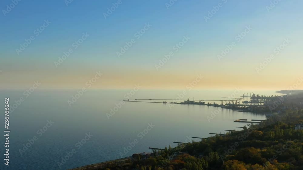 Sea coast and port in the evening. Autumn time. Aerial shooting Sea coast and port in the evening. Autumn time. Aerial shooting