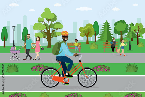 African american male cyclist riding in the park,different people on back plan