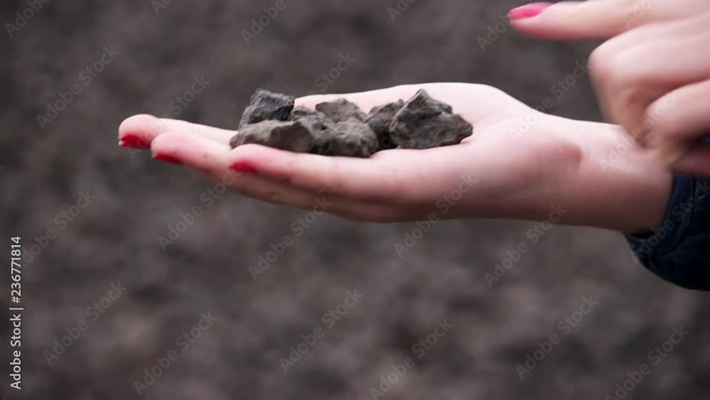 Crushed stone. On the hand are waste from the metallurgical plant. small pieces. Female hand. Crushed stone. On the hand are waste from the metallurgical plant. small pieces. Female hand.
