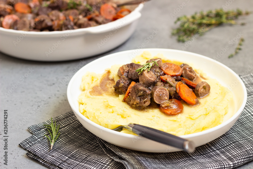 Beef bourguignon or meat stew with vegetables and herbs in a casserole. Beef bourguignon or meat stew with vegetables and herbs in a casserole.