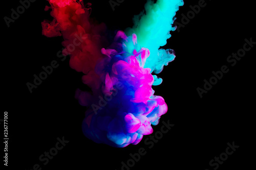 paint cloud in water, abstract background, process of mixing multicolored dye on a black background