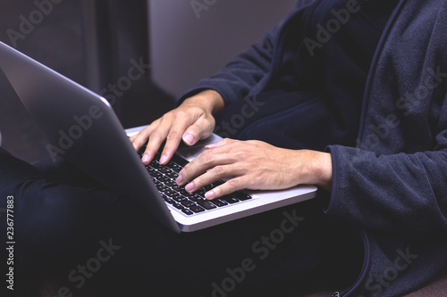 Close-up image of a young man working on his laptop at home. hands typing on keyboard laptop .