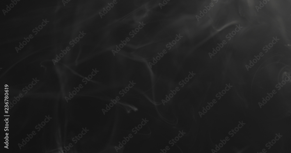 closeup vapor floating in air on black background closeup vapor floating in air on black background