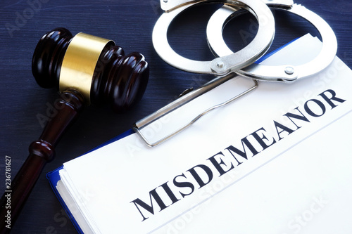 Documents with title misdemeanor and gavel. photo